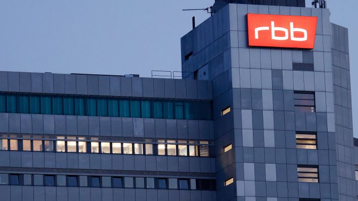 Das beleuchtete Logo des Senders Rundfunk Berlin-Brandenburg (RBB) ist an der Fassade am Sitz des Senders an der Masurenallee angebracht. (Quelle: dpa/Carsten Koall)