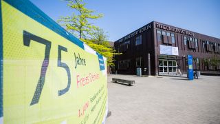 Ein JubilÃ¤umsbanner vor einem GebÃ¤udekomplex der Freien UniversitÃ¤t Berlin (Bild: dpa / Christoph Soeder)