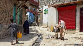 Menschen tragen WasserbehÃ¤lter in den StraÃen von Kabul (Hauptstadt in Afghansitan (Bild: picture alliance))