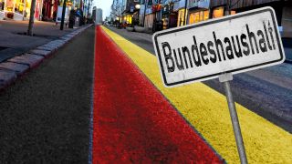 Montage: StraÃe mit vielen HÃ¤usern und Licht in Deutschland Landesfarben und einem Schild mit Aufschrift: Bundeshaushalt