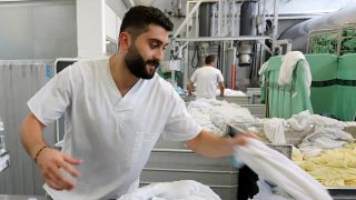 Der 24-jÃ¤hrige Obada Sakkaoui aus Syrien arbeitet im Textil-Dienstleistungsunternehmen Sitex in Rostock. (Archivbild)